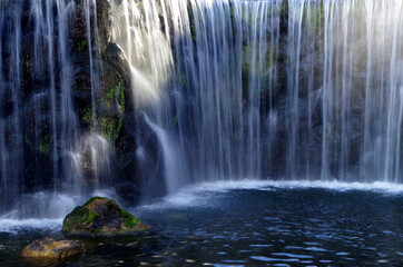 Cascading falls over stone in sunlight