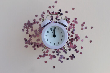 Alarm clock and heart confetti