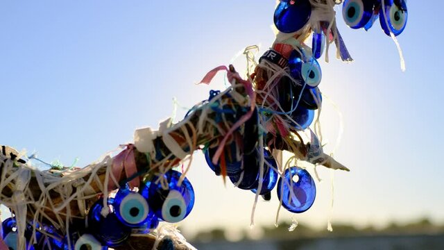 A lot of blue nazar eye sign hang on tree. Tree of dreams in Turkey. Amulet from the evil eye, protection of the house, superstition.