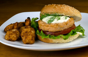 salmon burger top with tater sauce  and dill