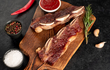 grilled marbled beef ribs on a stone background