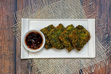 Crisp and chewy fried Chinese chive dumpling cake (Kanom Gui Chai) with chilli dark soy dipping...