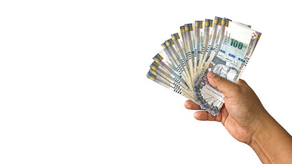 Close up of a hand holding fan shaped Peruvian 100 soles bills on white background