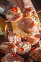 Sausage and peppers, artisan sausage with cheese and pepper on a wooden board, copy space and selective focus