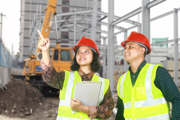 two construction workers or foreman discussing on site pointing finger