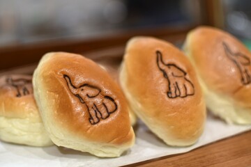 Newly baked bread buns with an image of an elephant etched on each one