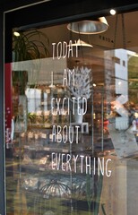 Positive inspiring message written on a glass wall of a retail storefront