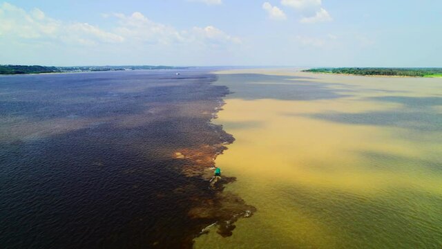 Manaus, Amazon. Connection of two streams of rivers with different density and color.