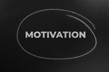 The Word motivation Written On The Chalkboard. motivation concept background.