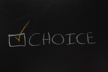 choice concept with selection mark and check mark, on blackboard background