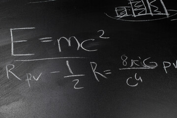 e=mc2 formula on blackboard, general theory of relativity formula, Einstein