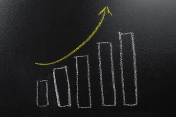 rising column chart on blackboard background