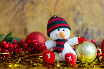 Fototapeta na wymiar Snowman plush toy with wooden background and Christmas lights.