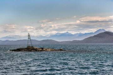 buoy over lake with background mountains and clouds