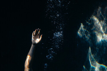 Hand under water reaching