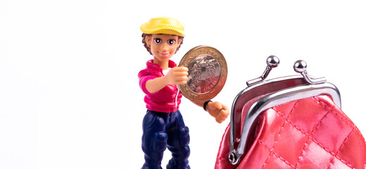 Plastic figurine of a conditional person places a 1 Turkish lira coin in a miniature red wallet