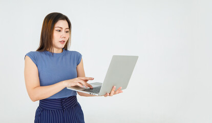 Charming Asian woman carry laptop and attentively typing message for online internet info...
