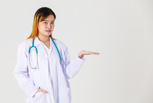 Portrait Studio Shot Asian Successful Professional Confident Dyed Hair Female Doctor In Lab Coat Hanging Stethoscope Around Neck Standing Smiling Holding Thumb Up Look At Camera On White Background