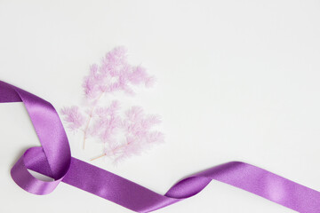 Purple flowers with purple ribbon on white background. 