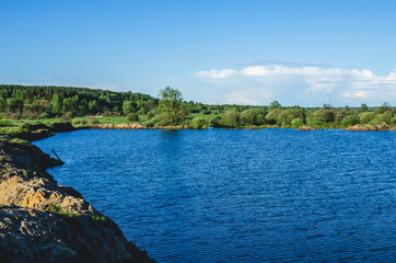 A flooded sand pit in the spring where sand mining was finished