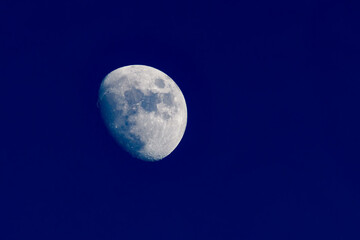 Clear image of waxing gibbous moon on clear blue evening.