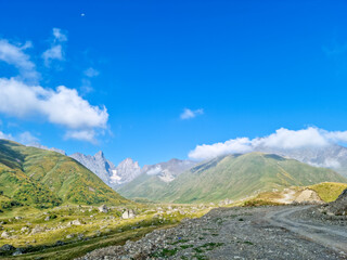 A panoramic view on the sharp mountain peaks of the Chaukhi massif in the Greater Caucasus Mountain Range in Georgia, Kazbegi Region. The valley is full of the Roshka stones. Georgian Dolomites.