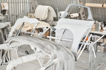 Various parts of the car on the stands for painting. Garage painting car service. Repairing car...