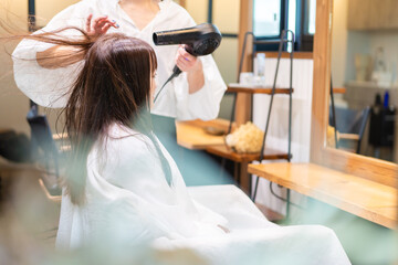 ヘアドライヤーを使う美容師