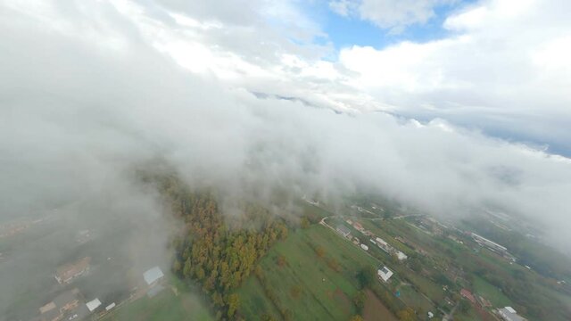 FPV video, flying at high speed over the clouds. Concept of skydiving, airplane crash.