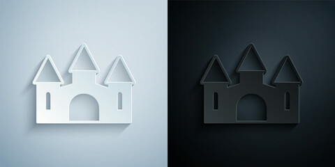 Paper cut Castle icon isolated on grey and black background. Medieval fortress with a tower. Protection from enemies. Reliability and defense of the city. Paper art style. Vector