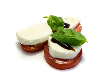 mozzarella basil and tomatoes isolated on white background