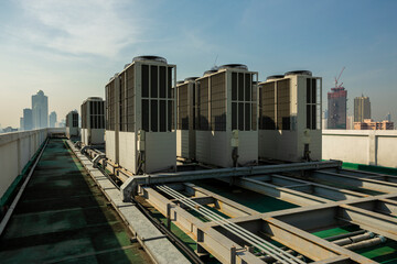 Exhaust vents of industrial air conditioning and ventilation units. Skyscraper roof top from high building.