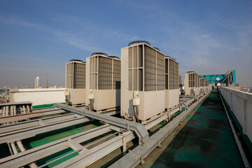 Exhaust vents of industrial air conditioning and ventilation units. Skyscraper roof top from high building.