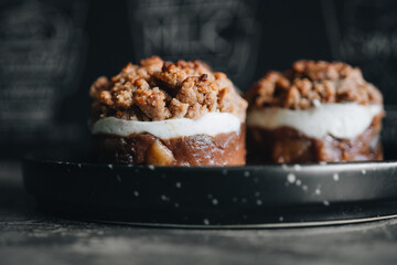 Apple crumble dessert on black plate