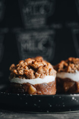 Apple crumble dessert on black plate