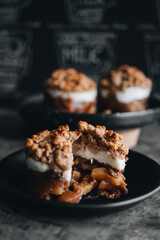 Apple crumble dessert on black plate