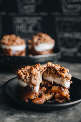 Apple crumble dessert on black plate