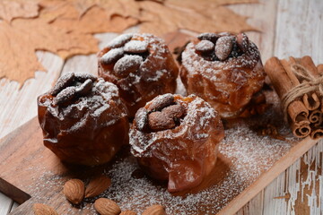 Baked apples with nuts and raisins. Homemade baked apples in the oven, with sugar powder close-up. Holiday dessert