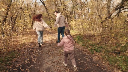 little kid runs catching up with mother and father, happy family, active children outdoor games autumn, cheerful joyful child with mom and dad laughing, vacation travel together, children dream fun