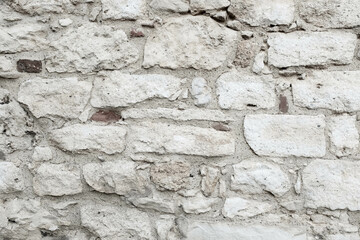 Old stonewall and new red bricks. Art stone texture. The backdrop surface has a natural color. Stone background for branding, calendar, multicolor card, banner, cover, header for website