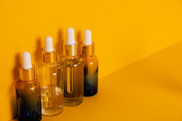 Dropper glass bottles with pipette. Transparent hyaluronic natural beauty mineral product and eco serum skin care concept. Top horizontal view copyspace. Summer juicy colors.