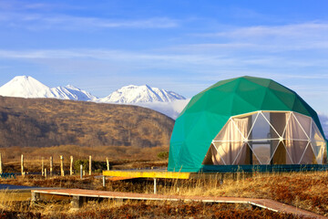 Green geo-dome tent on Kamchatka peninsula. Cozy, camping, glamping, holiday, vacation lifestyle concept. Outdoors cabin, scenic background