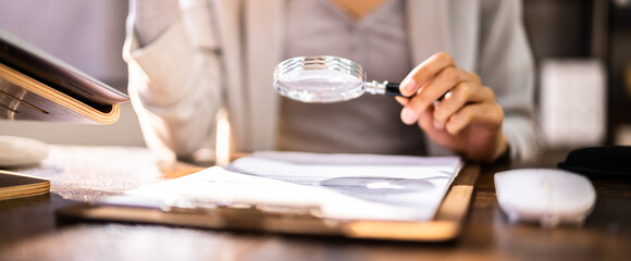 Corporate Auditor Using Magnifying Glass