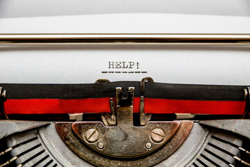 Call for help typed on an old typewriter. Macro shot.