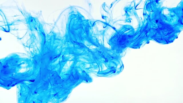 Color ink in water on white background. Paint drops mixing in water, Ink swirling underwater. Colored cloud abstract smoke explosion. Abstract color mix. Macro shot. High quality FullHD footage