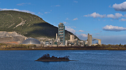 View of huge industrial cement plant in Bow Valley near Canmore, Alberta, Canada in the Rocky...