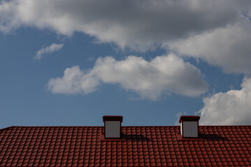 chimney on the roof of the house against the blue sky