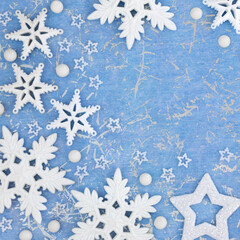 Christmas background with white star, snowflake and ball tree decorations on mottled blue. Abstract winter, Xmas and New Year composition.