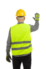 Man in reflective clothes and hardhat is standing with hand raised and showing stop gesture. Rear view.
