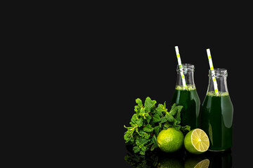 Background photography of green vegetable juice, vegetable fresh, lime, mint, bottle with straw on a black background, healthy lifestyle, blank, copy space, add text.